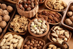 Many different types of nuts lie side by side in bowls